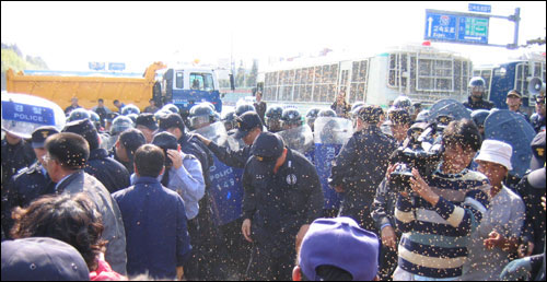 농민들은 나락을 흩뿌리며, 경찰의 원천봉쇄에 항의했다. 